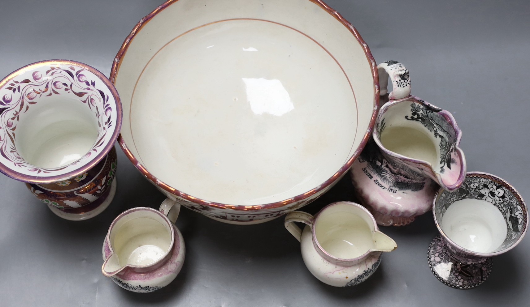 A group of early 19th century pink lustre vases and jugs and a junket bowl